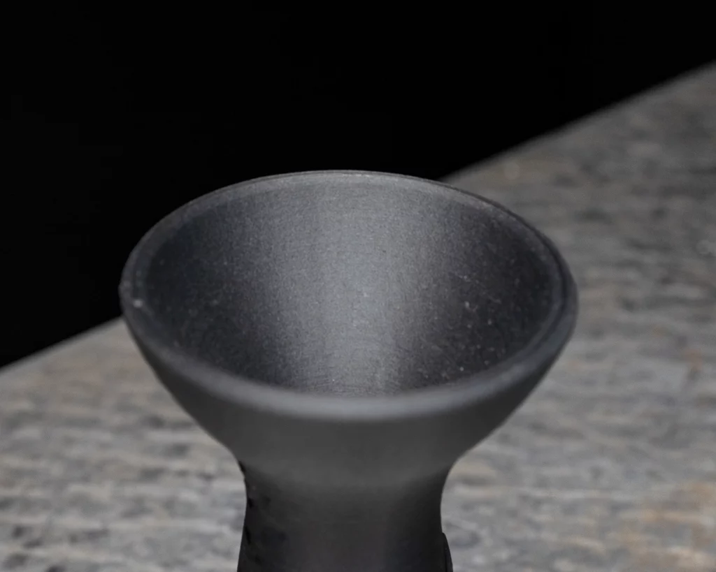 3D printed onyx exhaust manifold with a wide flared inlet tapering to a cylindrical outlet